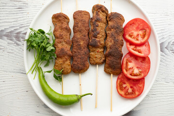 Close-up of traditional Turkish shish kebabs on oval plate