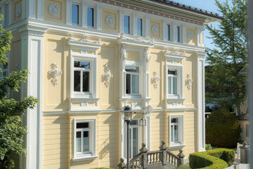 Historic villa with ornate architecture located in a tranquil garden setting under bright sunlight...
