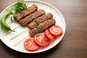 Close-up of traditional Turkish shish kebabs on oval plate
