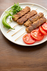 Close-up of traditional Turkish shish kebabs on oval plate