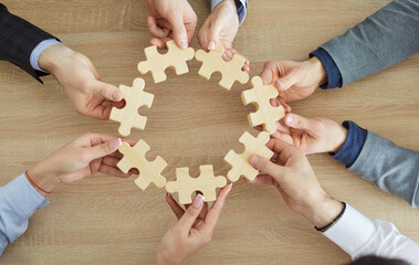 Common unity team jigsaw puzzle circle matching, business teamwork game pieces showing cooperation partnership, hands close up join pieces in office, business people together for team business idea 