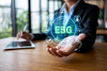 Businesswoman showing esg environmental social governance interface with icons in a meeting