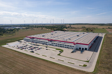 Factory and Wind Turbines: Aerial View of Modern Manufacturing