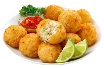prato com bolinho de bacalhau acompanhado de molho de pimenta e fatia de limão isolado em fundo...