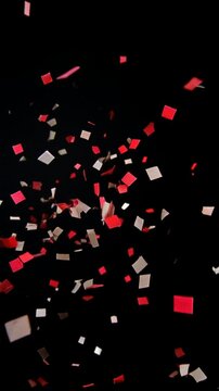 Burst of red and white confetti on a black background