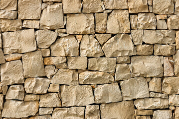 Background texture stone wall, made of rectangular stones. Close-up
