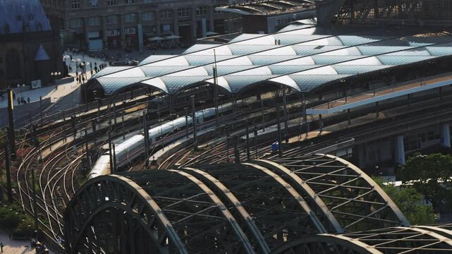 Modern high speed ICE passenger train arrive at Hauptbahnhof Htb main station in Cologne, Geramany at sunset, aerial veiw