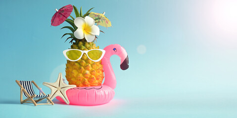 Pink inflatable flamingo and pineapple in sunglasses. Summer pool float party idea. Summer concept.