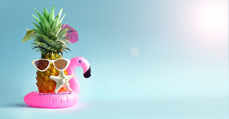 Pink inflatable flamingo and pineapple in sunglasses. Summer pool float party idea. Summer concept.