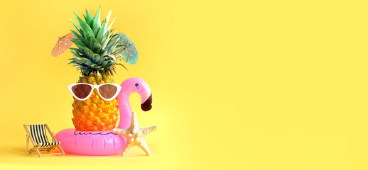 Pink inflatable flamingo and pineapple in sunglasses. Summer pool float party idea. Summer concept.
