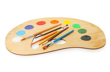 Wooden palette with paints and brushes isolated on white