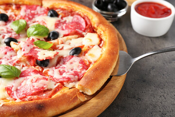 Tasty pizza served on grey table, closeup