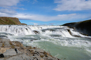 View of the waterfall from the rocky shore