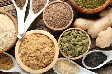 Different superfood products on wooden table, flat lay