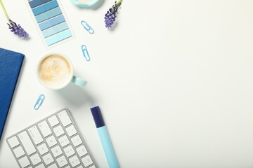 Flat lay composition with stationery, coffee and flowers on white background. Space for text
