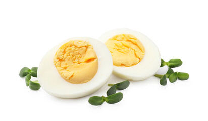 Halves of hard boiled eggs with microgreens isolated on white