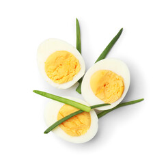 Halves of hard boiled eggs with green onions isolated on white, top view
