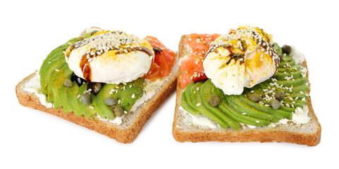 Delicious sandwiches with avocado, poached egg and salmon isolated on white