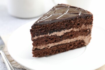 Piece of delicious chocolate cake on table, closeup
