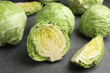 Fototapeta premium Fresh green cabbages on grey table, closeup