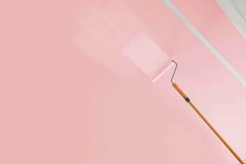 Painting ceiling with pink dye indoors, low angle view