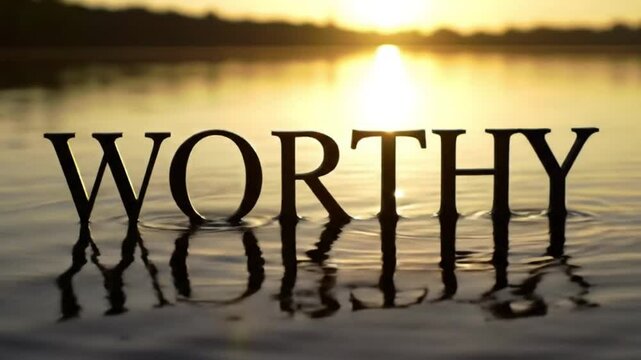 “WORTHY” in elegant reflective text over calm water and rising sun — serene affirmation with graceful visual design

