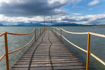 Naklejka premium Puerto Natales is a city in Chilean Patagonia. It is the capital of both the Natales and the province of Última Esperanza Chile The seashort has a marvelous landscape with fjords and the Andes