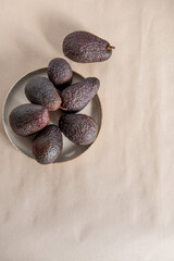 The Hass avocado on the background of craft paper top view. flatlay