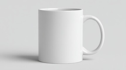 Obraz premium Pristine white ceramic mug positioned against neutral gray surface, highlighting minimalist design and clean visual simplicity of everyday drinkware