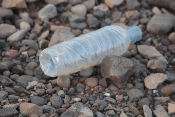 A plastic bottle lying on the ground, Plastic pollution