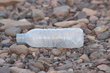 A plastic bottle lying on the ground, Plastic pollution