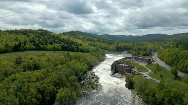 Aerial View of Hydroelectric Dam and Waterfall in Maine Forest, drone 4K