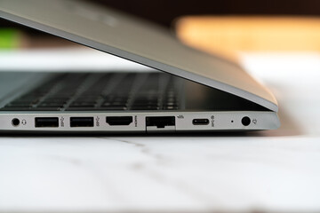 Close up detail of the side panel connectivity on a modern laptop, showing various input and output...