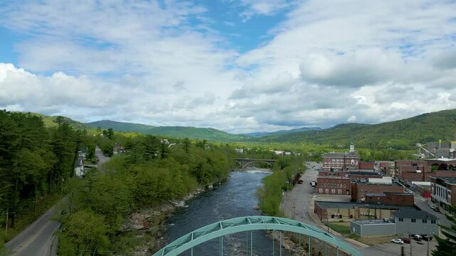 Aerial View of Small Town in Maine with River, Bridge, and Mountain Landscape, drone 4K