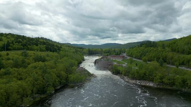 Aerial View of Hydroelectric Dam and Waterfall in Maine Forest, drone 4K