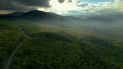 Aerial View of Lush Mountain Forest Landscape in Maine Under Dramatic Sky