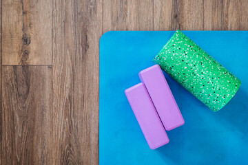 Mat and roller for Yoga or Pilates classes, flat layout with copies of health concepts and daily...