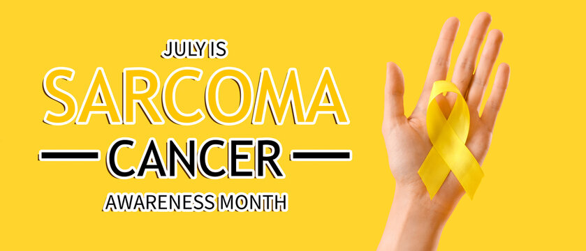 Woman with yellow awareness ribbon on color background, closeup