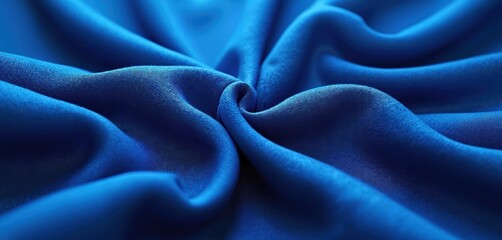 Obraz premium Cobalt blue fabric background with a textured surface. Elegant waves and folds create a dynamic design. Abstract textile material for fashion interior design. Perfect for any artistic project.