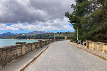 Obraz premium Los Bermejales Reservoir is a tranquil body of water surrounded by scenic natural landscapes and pine forests in the province of Granada, Spain