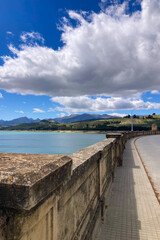 Obraz premium Los Bermejales Reservoir is a tranquil body of water surrounded by scenic natural landscapes and pine forests in the province of Granada, Spain