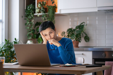 Tired overloaded mature woman with glasses off, look at laptop at home. Fatigue. Adult female...