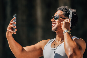 latino man with headphones and cell phone