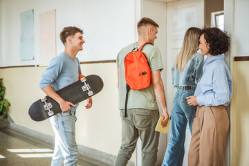 The teacher welcomes the students as they enter the classroom
