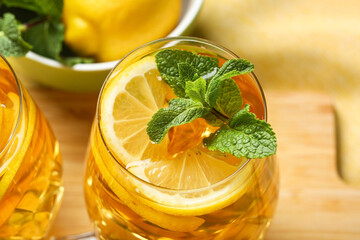 Glass of lemon ice tea with mint on napkin, closeup
