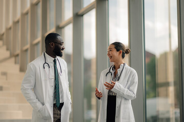 Doctors discussing a medical case in hospital corridor
