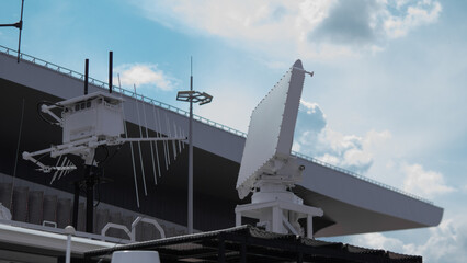 Military Surveillance Equipment Deployed on a Warship in a Coastal Area, Demonstrating Readiness...
