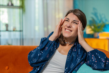 Sick ill Caucasian woman rubbing temples to cure headache problem, suffering from tension and...