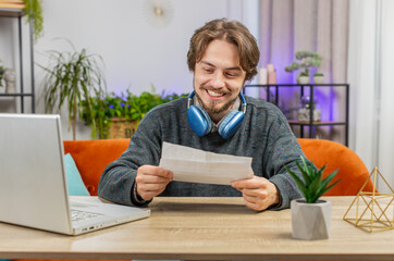 Happy Caucasian man open envelope letter, reading it. Career growth advance promotion, bank loan...