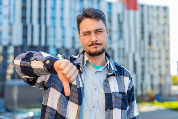 Dislike. Upset Caucasian mature man showing thumb down sign gesture, expressing discontent...